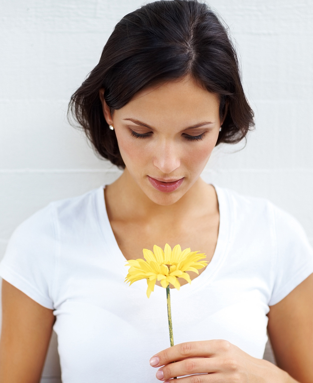 Lady holding yellow flower to represent Fashion Cleaners GreenEarth Eco-Friendly Dry Cleaning